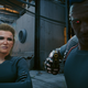 Two NPCs in Cyberpunk 2077 stare the player down.